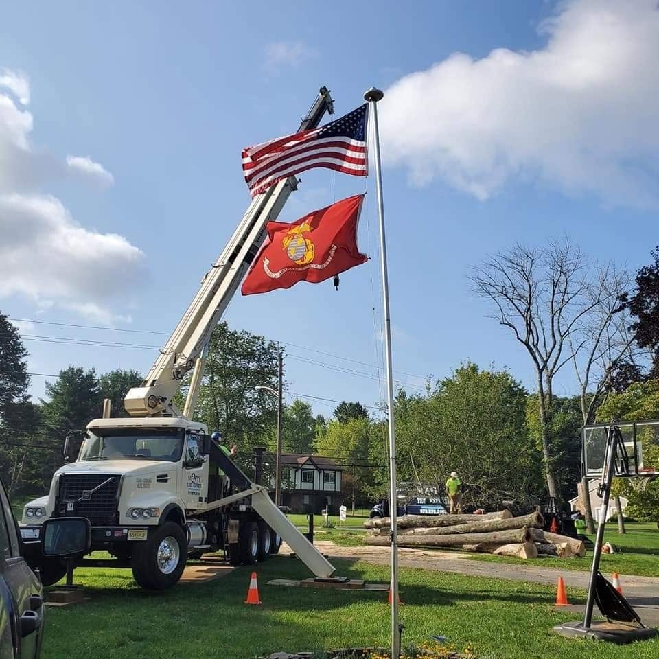 Truck-mounted crane working near flagpoles