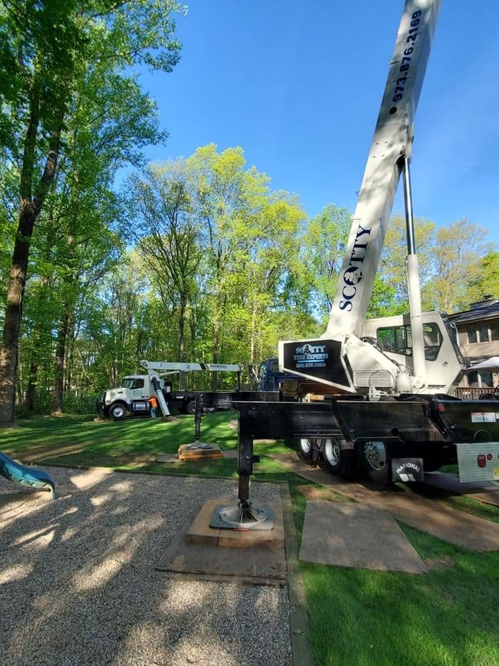 Two crane trucks positioned at a residential property
