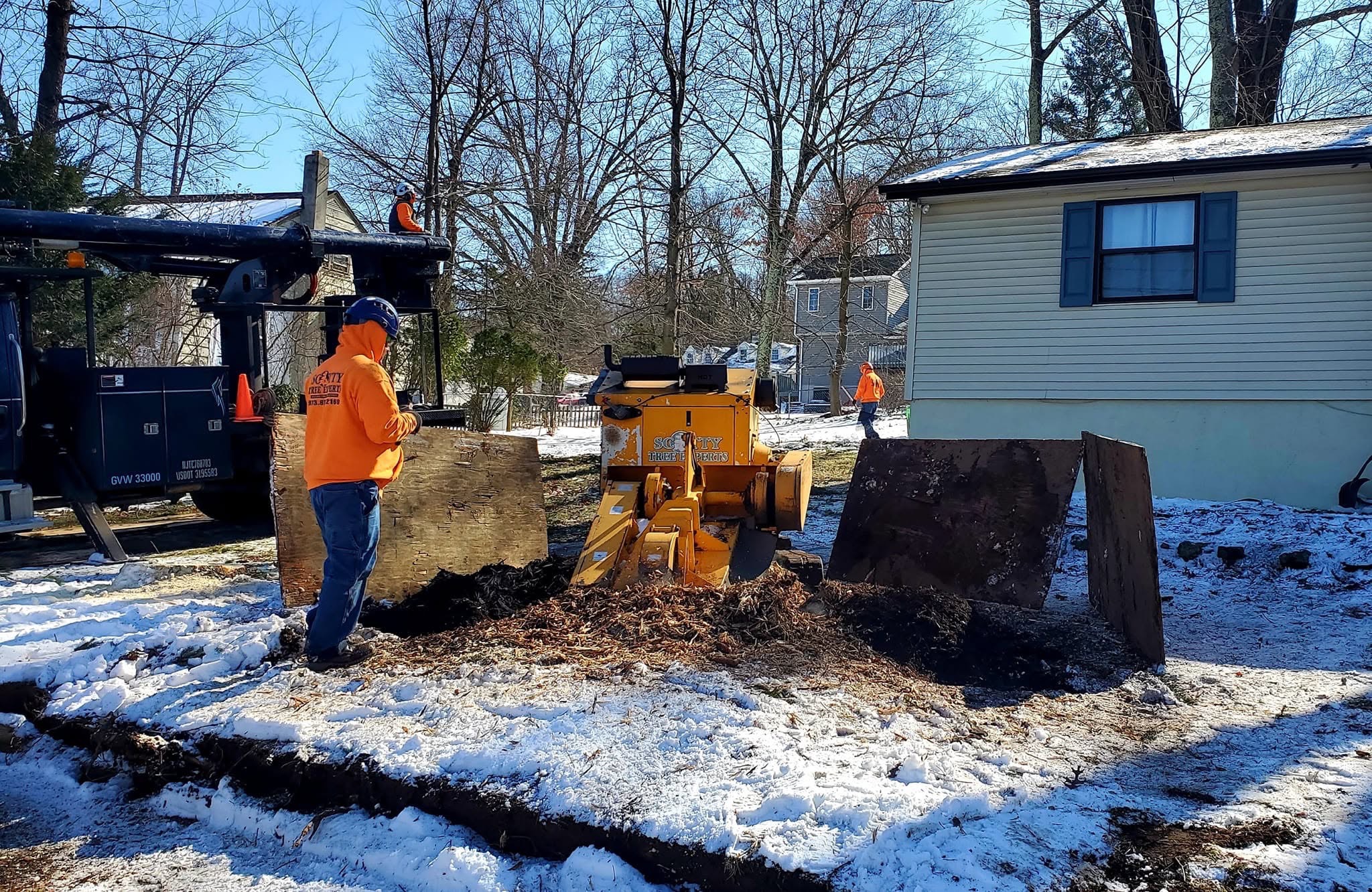 Stump grinder working on a snowy day